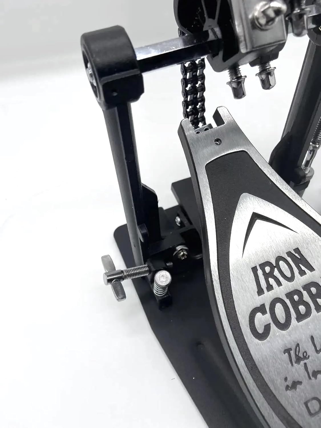 Close-up of a drum pedal with 'Iron Cobra' branding on a white background