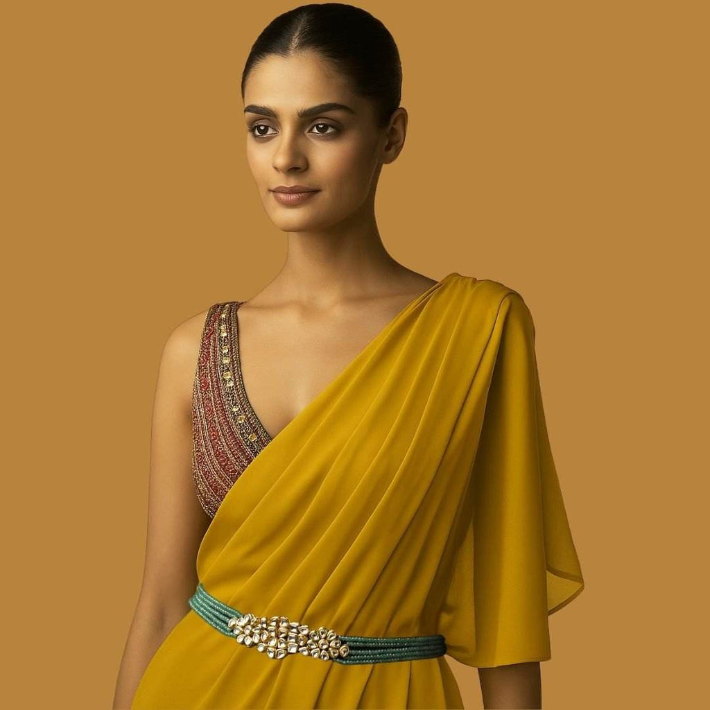 Woman wearing a yellow saree with a brown background


