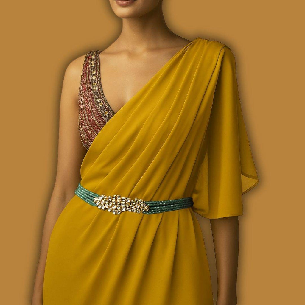 Yellow saree with a decorative belt on a brown background

